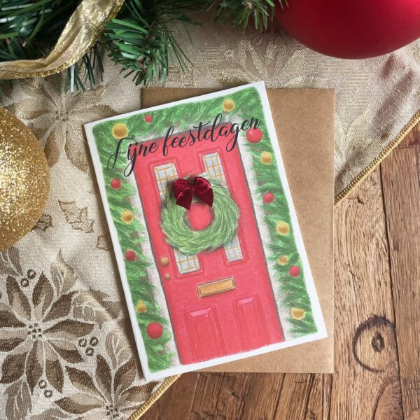 Kerstkaart versierde deur